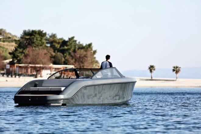 person at the helm of a speed boat