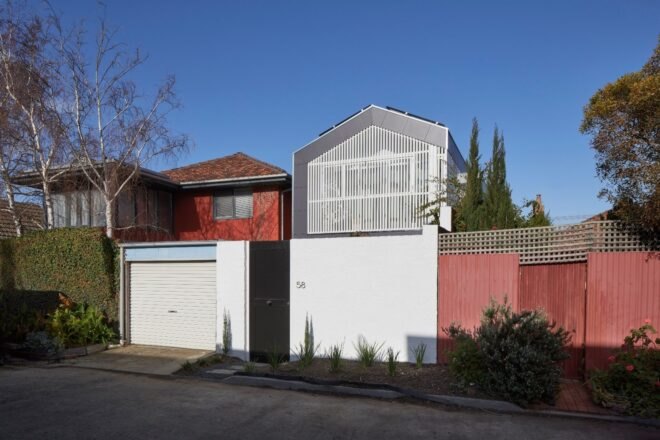 white and gray home with gabled roof
