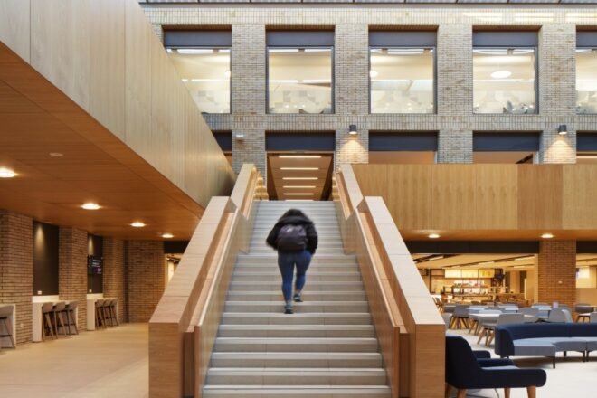 person walking up large stairwell