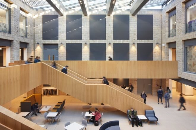 students walking up large wood staircase