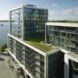 condo building with glass walls and a green roof