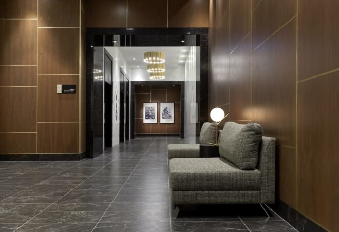 lobby with brown walls and gray sofa