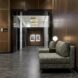 lobby with brown walls and gray sofa