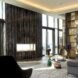 gray sofa and black chair facing a wall of glass