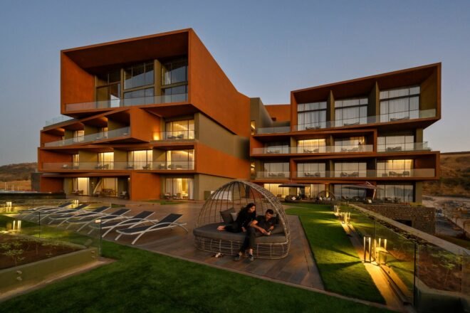 evening shot of hotel with several balconies