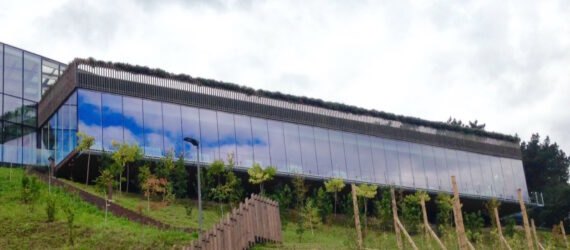 long building with glass walls on a hill