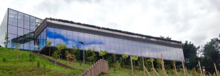 long building with glass walls on a hill