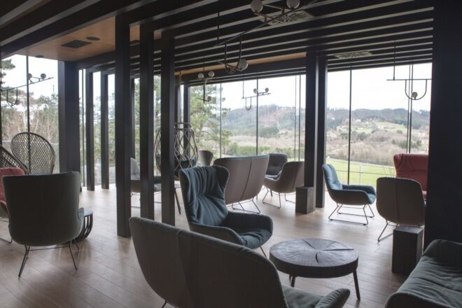 lounge chairs in a room with glass walls