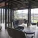 lounge chairs in a room with glass walls