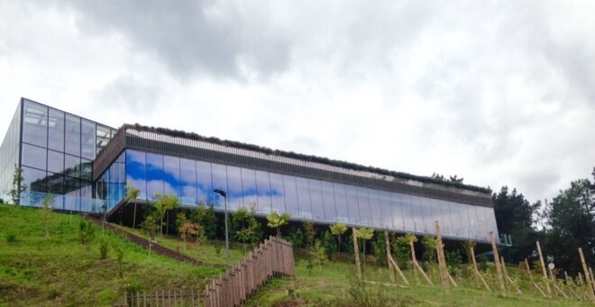 long building with glass walls on a hill