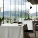 cloth-covered tables beside walls of glass