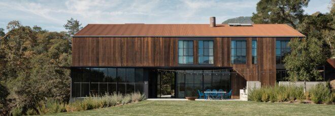 elongated two-story home clad in wood