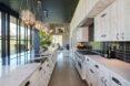 large kitchen with pendant lights and white cabinets and island