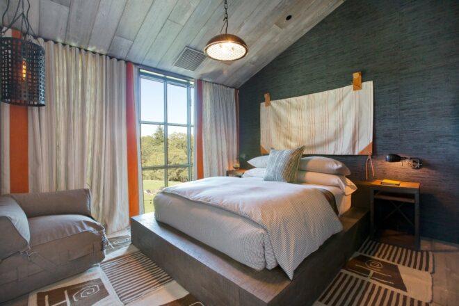 bedroom with dark walls and a platform bed