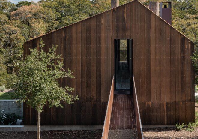 walkway leading up to wood-clad home
