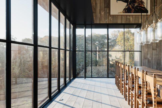 all-glass enclosure inside barn home