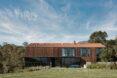 elongated two-story home clad in wood