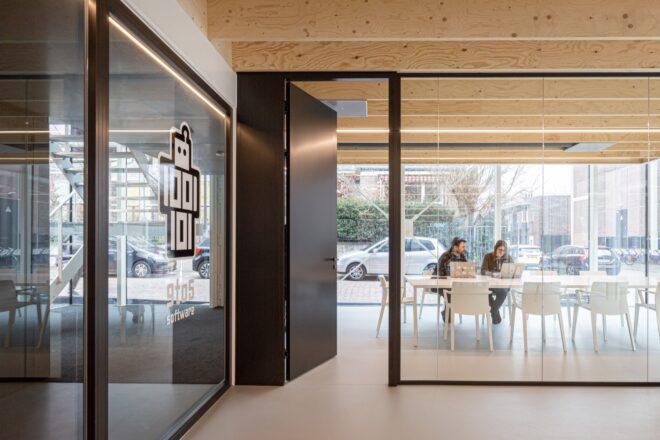 black door leading to meeting room with glass walls