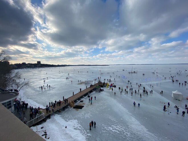 people walking on a frozen lake