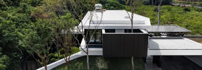 white and black home surrounded by trees