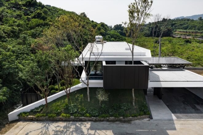 white and black home surrounded by trees