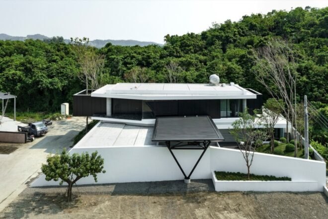 white and black home surrounded by trees and mountains