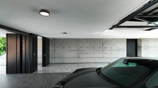 black sports car parked in a concrete garage