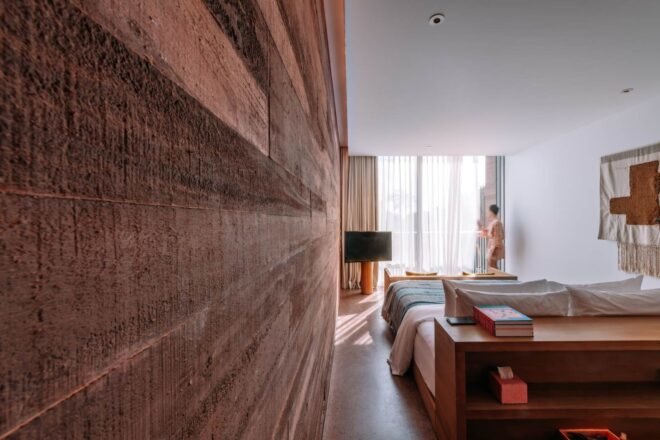 hotel room with large bed and brick walls