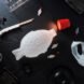white fish-shaped lamp near sushi, chopsticks and plastic bags
