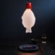 fish-shaped lamp hanging above a dining table