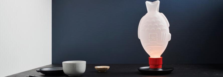 fish-shaped lamp on dark table
