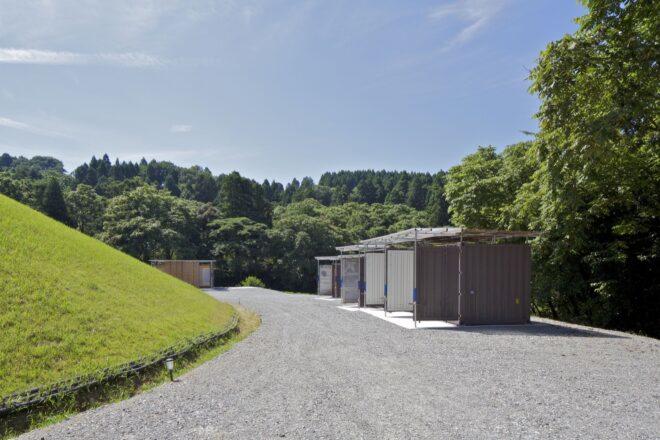 gravel path leading to gray buildings