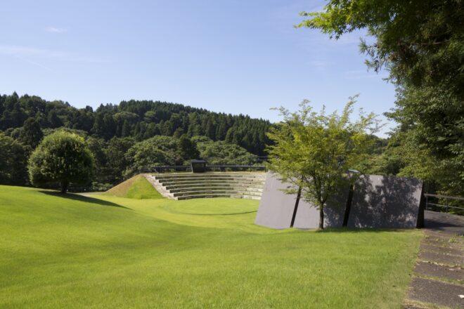rolling green hills leading to an outdoor amphitheater