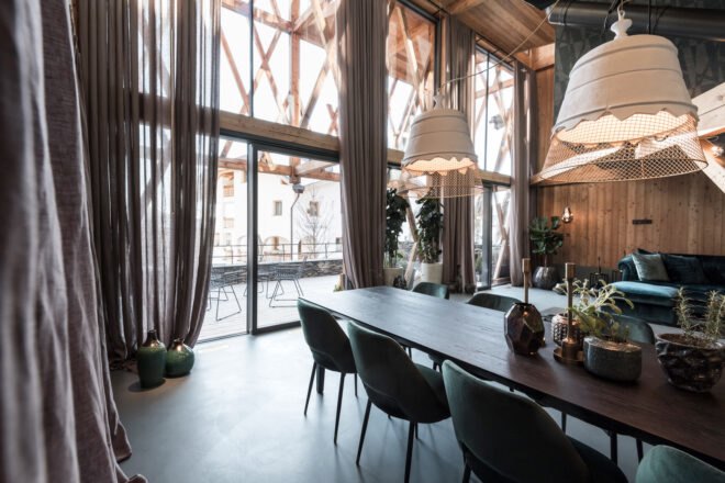 dark wood dining table near large glass wall