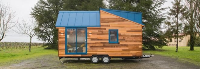 tiny home on wheels with sliding glass door entry