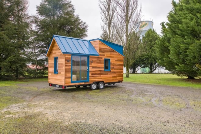 tiny wooden home on wheels with pitched roof