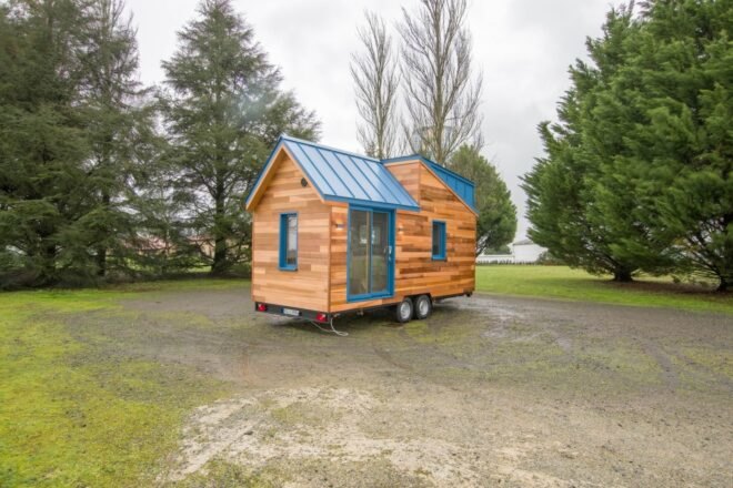 tiny home clad in honey-hued wood panels