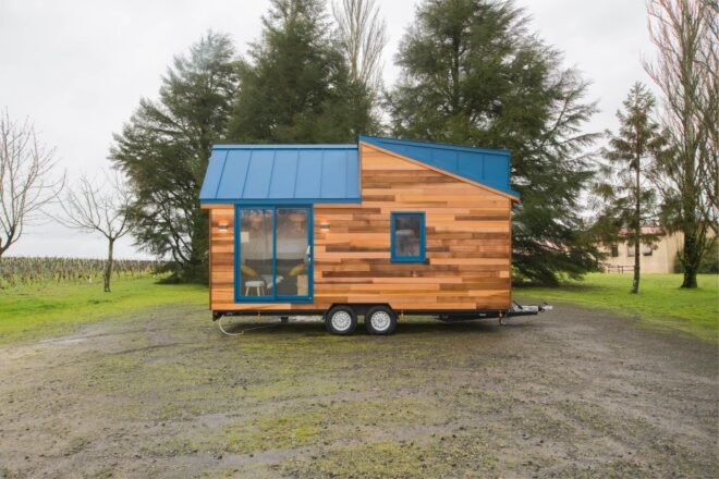 tiny wooden home with aluminum blue roof