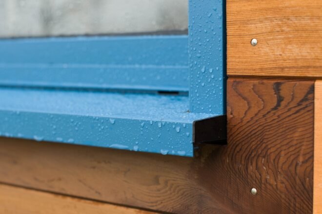blue aluminum fixture on wooden exterior