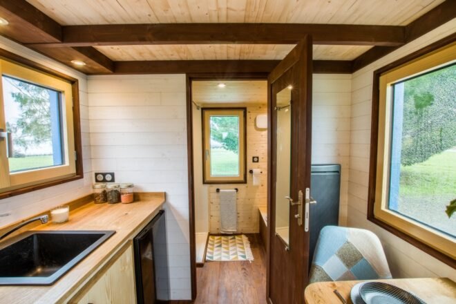 interior kitchen space with bathroom in the background