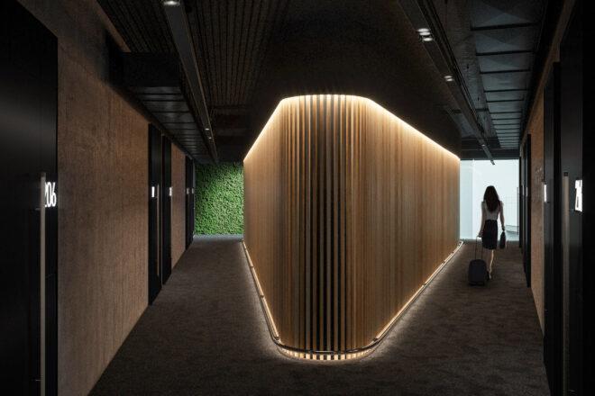a split, V-shaped hallway with lit-up walls