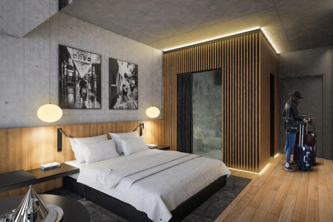 a hotel bedroom with art on the walls and a person walking in the door
