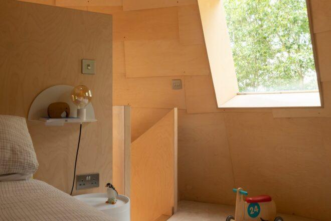wood-lined bedroom with large square window