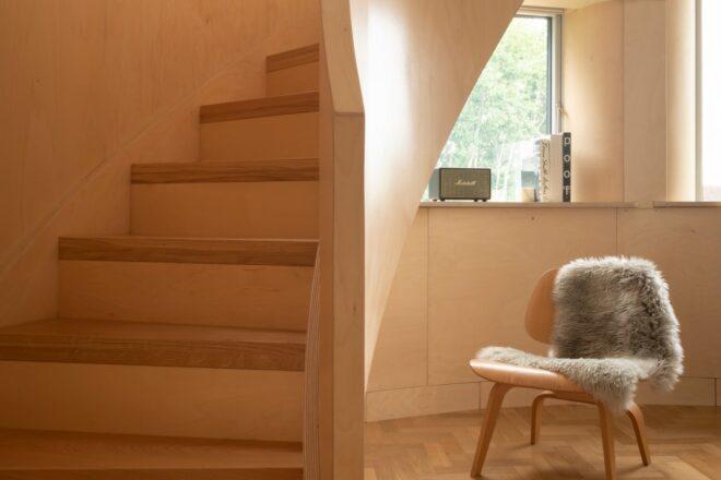 small nook with chair beside timber staircase