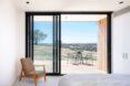 white room with tan chair near a sliding glass door