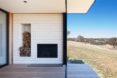 white fireplace near wall of glass
