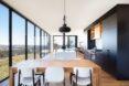 wood table near a black and white kitchen