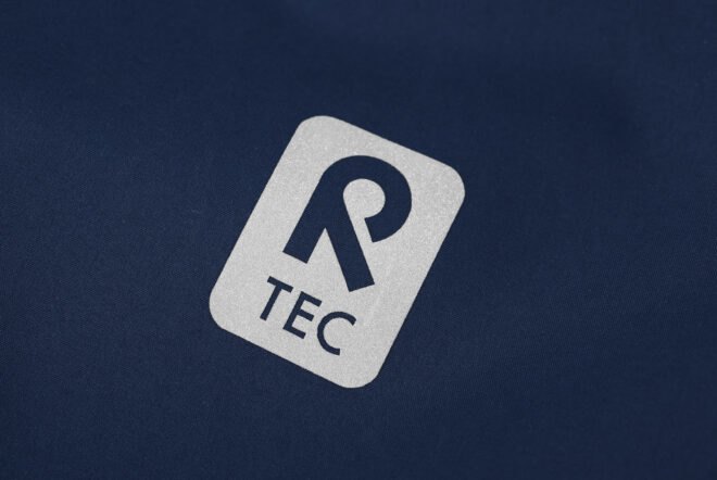 silver label that reads, "R TEC" on a blue jacket