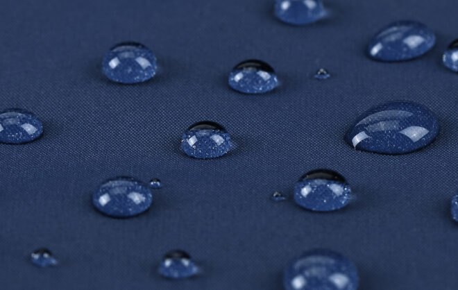 water droplets on blue waterproof jacket