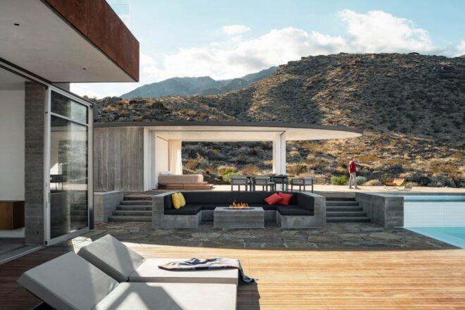 large wooden deck with lounge chairs